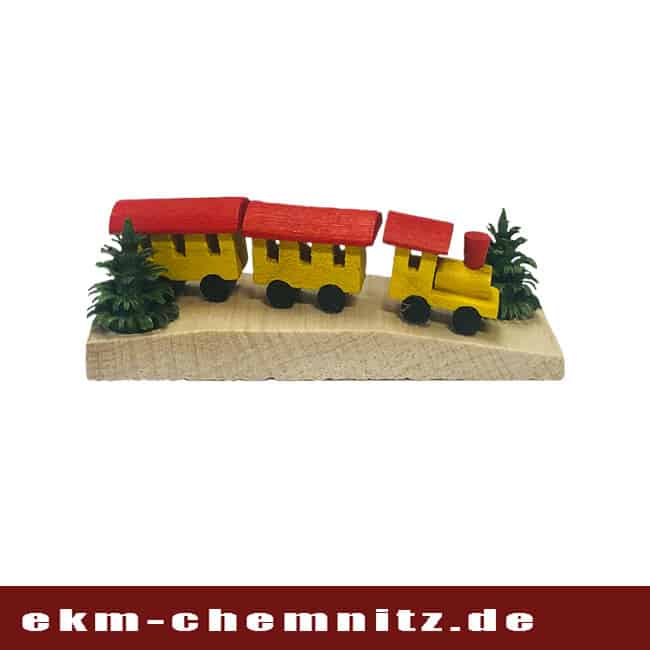 Miniatur Eisenbahn auf Brettchen gelb Eine kleine Eisenbahn in gelb auf einem Miniatur Brettchen.
