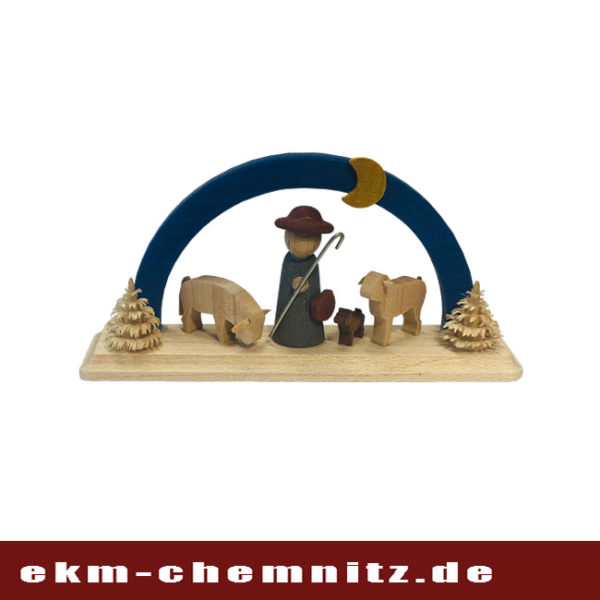 Ein Schäfer mit Hund und Schafen auf einem blauen Miniatur Schwibbogen.